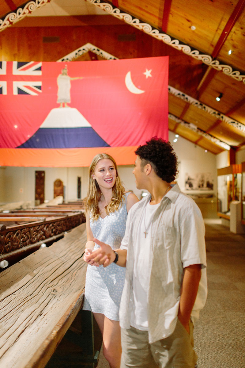 Two young adults view the waka in Whanganui Regional Museum
