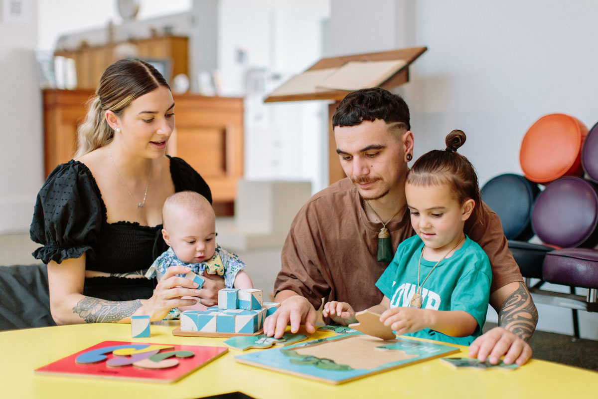 A young family enjoy the activiies table at the Whanganui Regional Museum